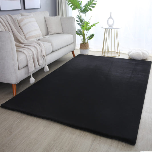 Black Plushtale washable fluffy rug, in a room setting