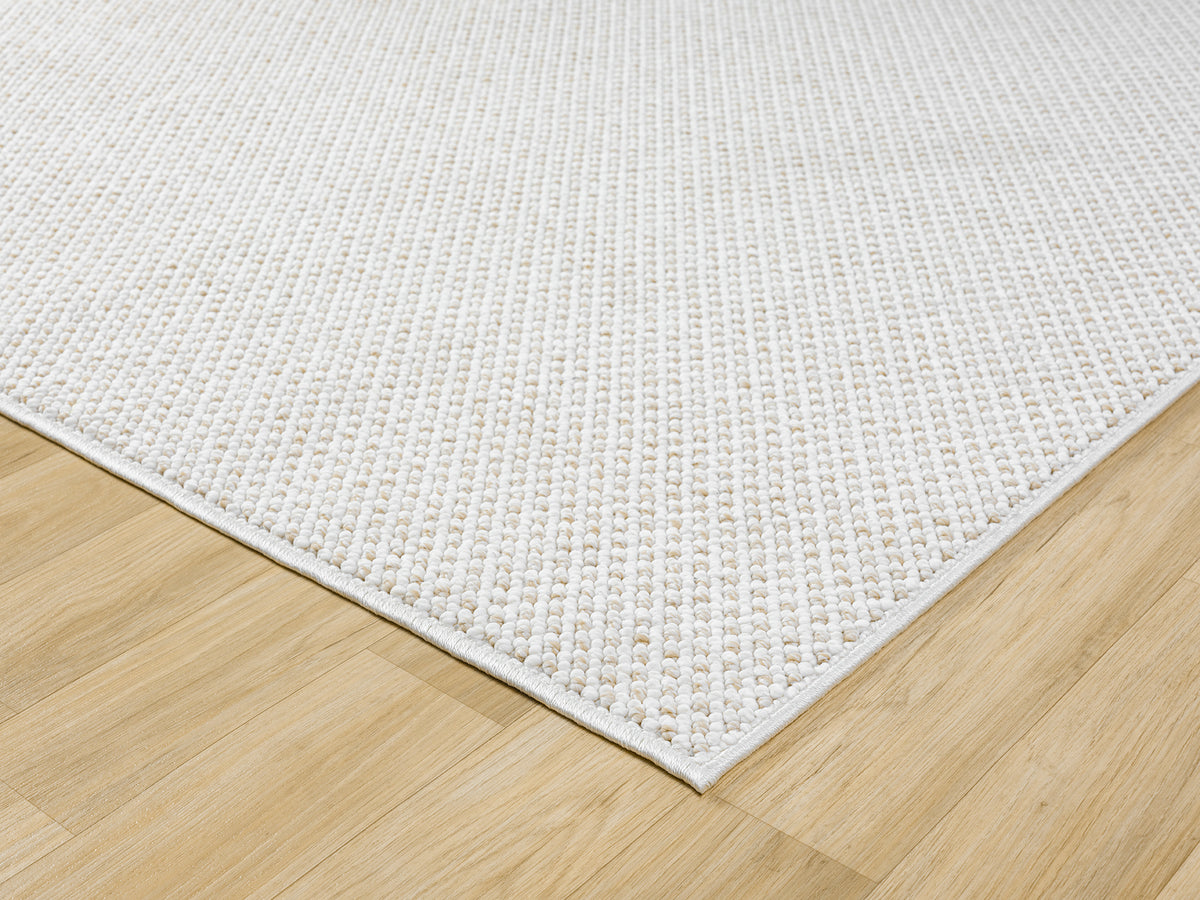 Cream Avior Mottle bobble rug, corner fold detail