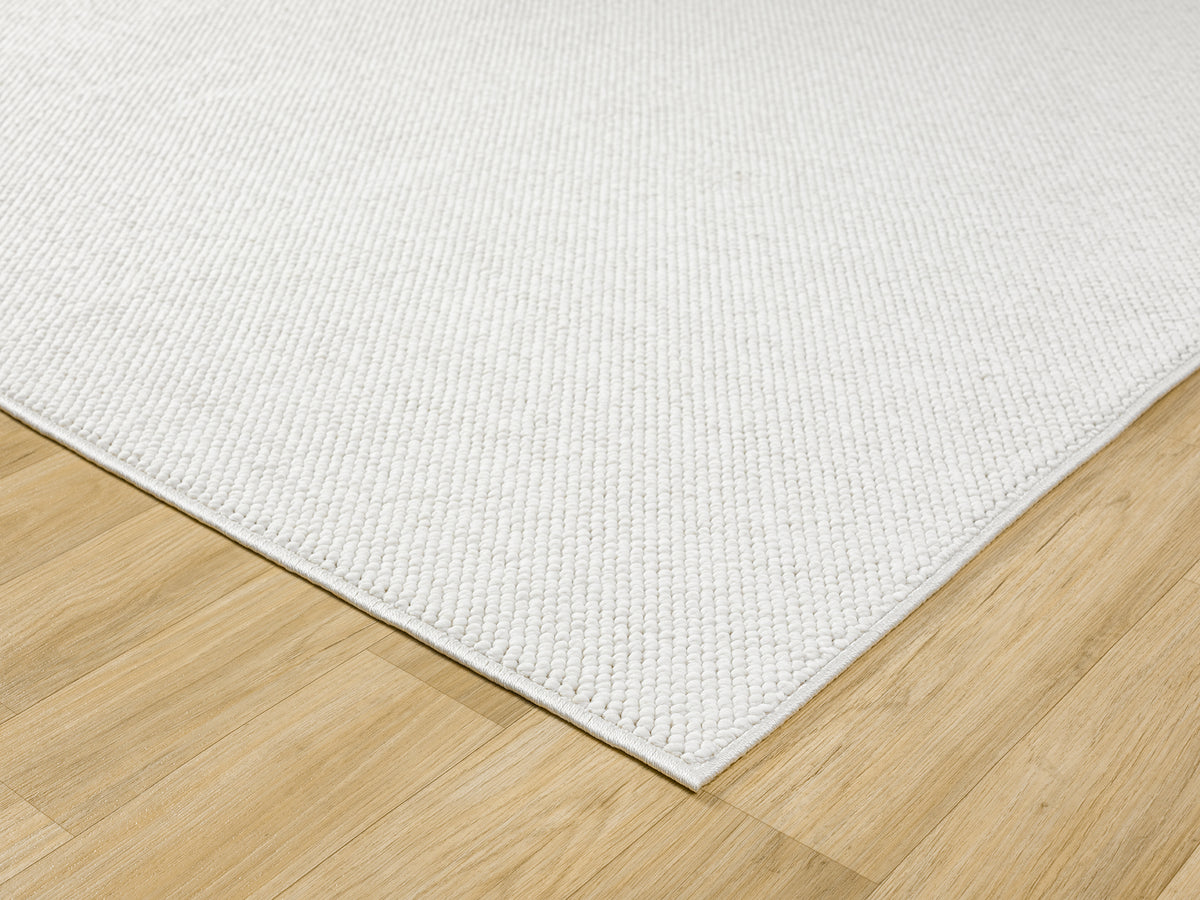 Cream Avior bobble rug, corner fold detail