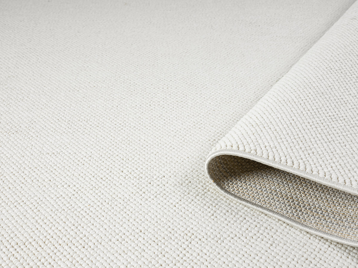 Cream Avior bobble rug, rolled view