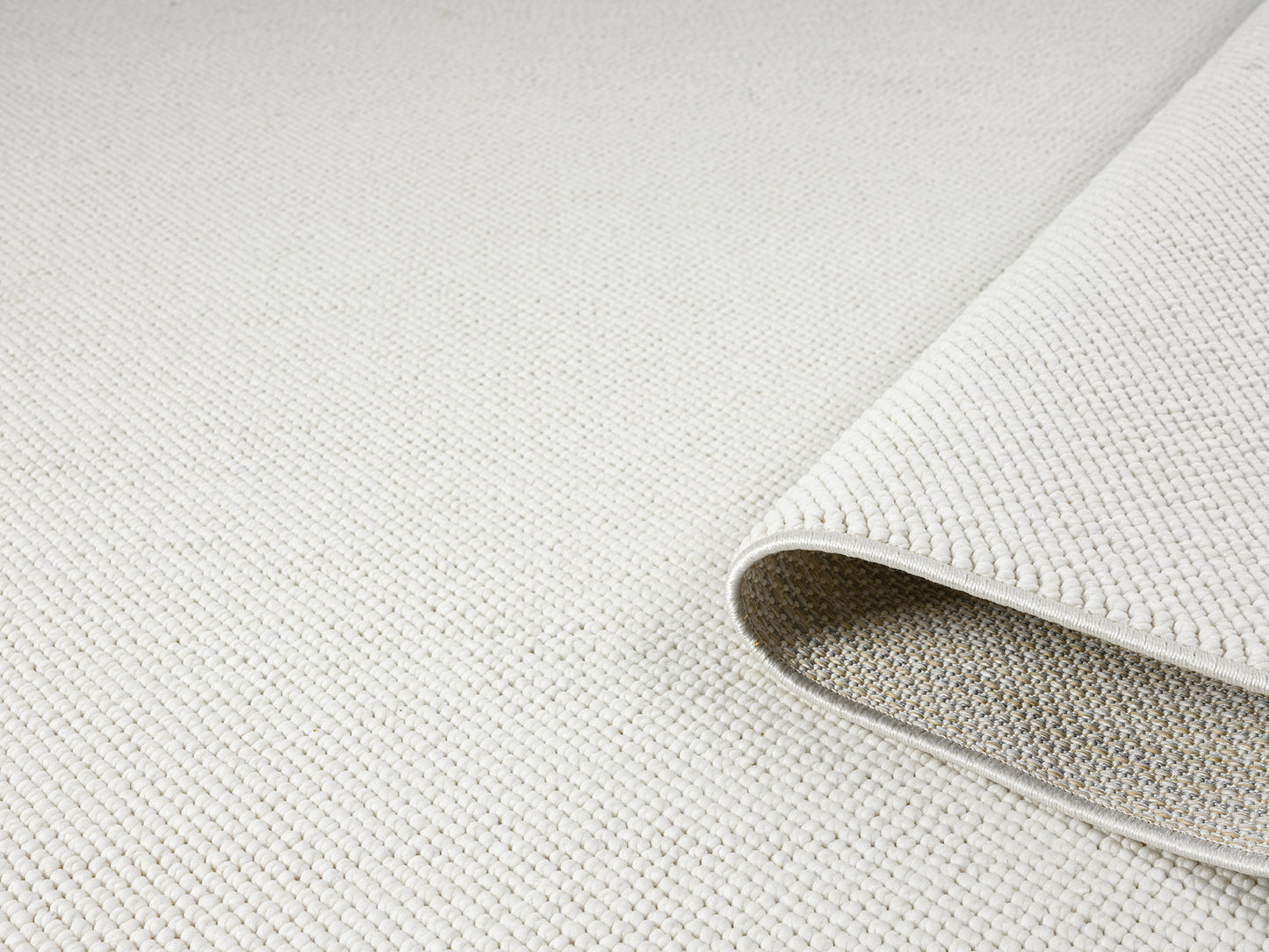 Cream Avior bobble rug, rolled view
