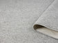 Grey Avior bobble rug, rolled view