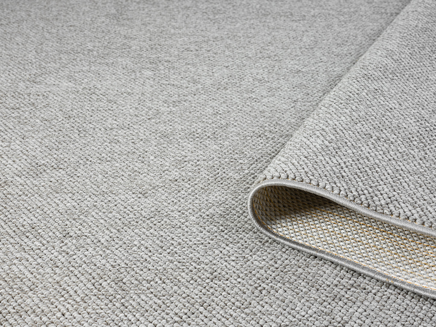 Grey Avior bobble rug, rolled view