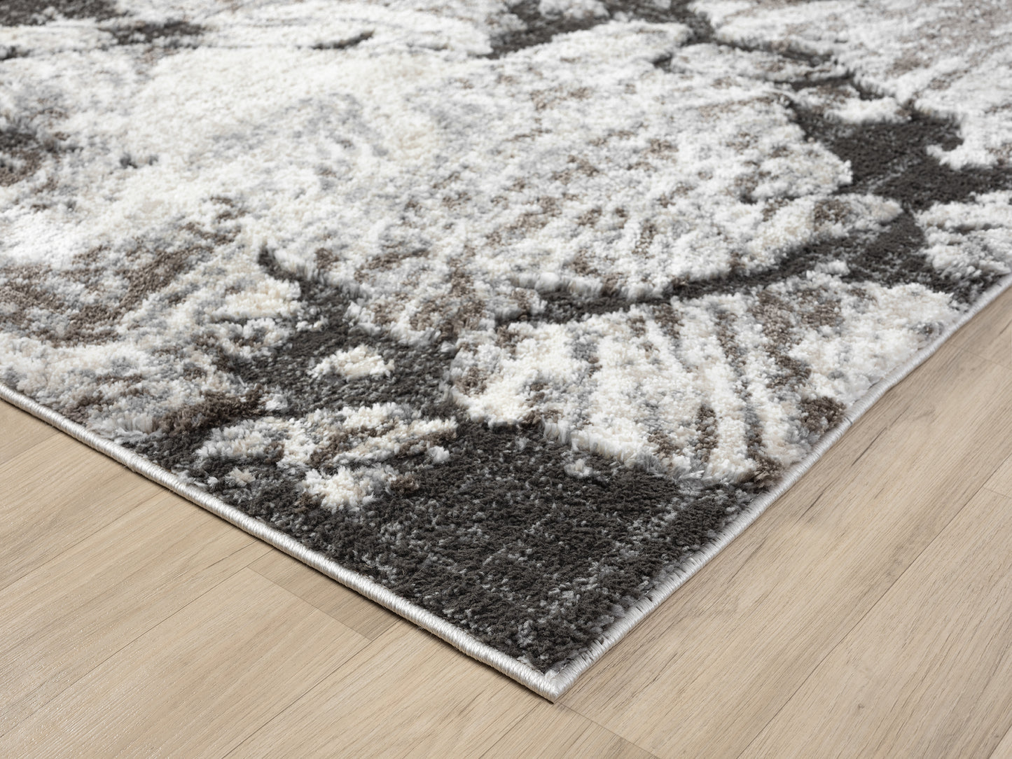 Grey Eleanor Astro embossed abstract rug, corner fold detail