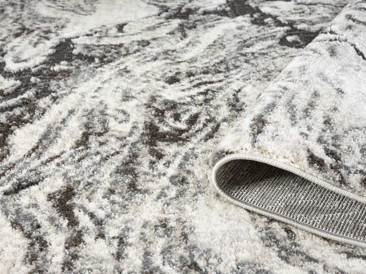 Grey Eleanor Astro embossed abstract rug, rolled view