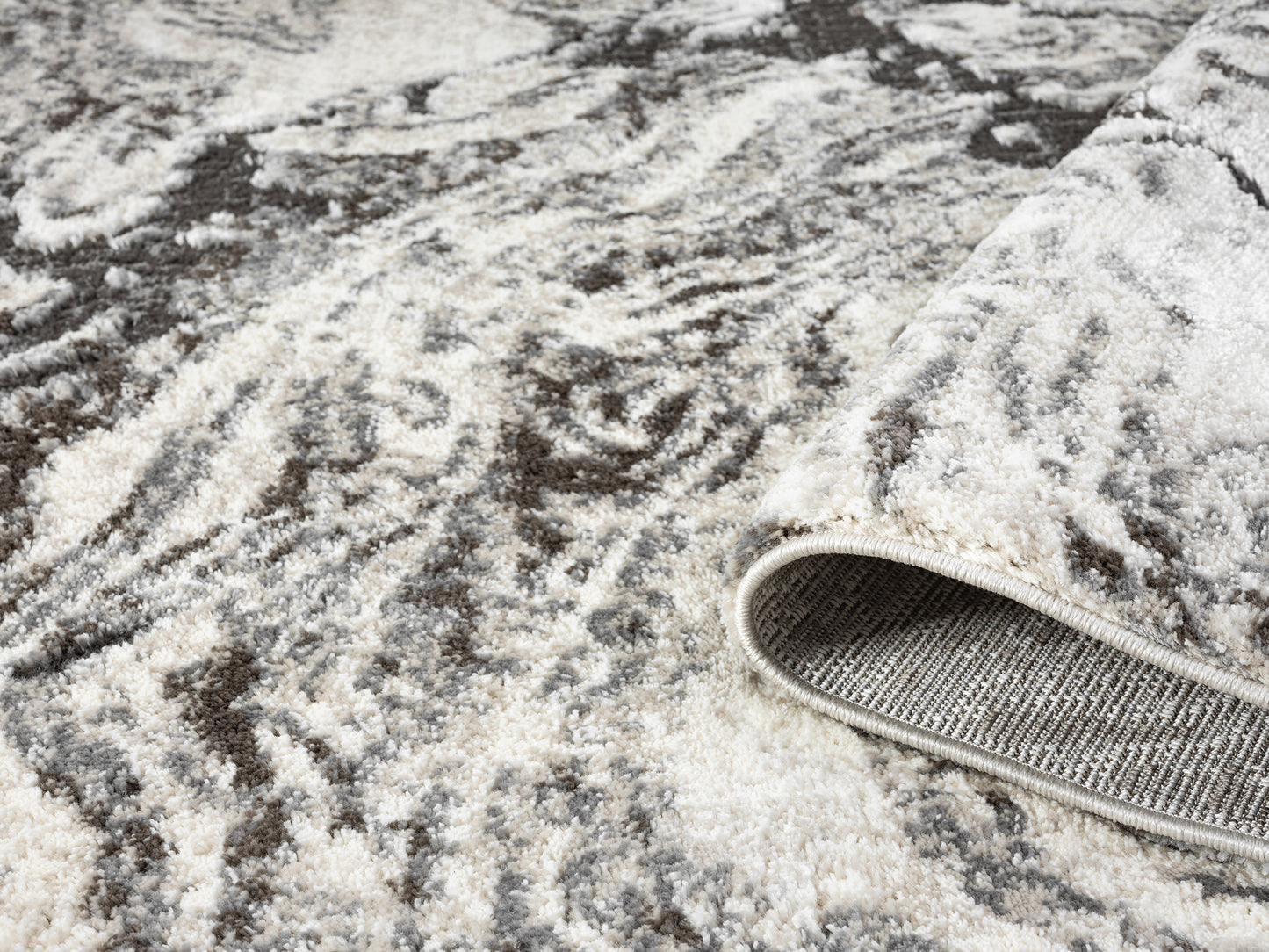 Grey Eleanor Astro embossed abstract rug, rolled view
