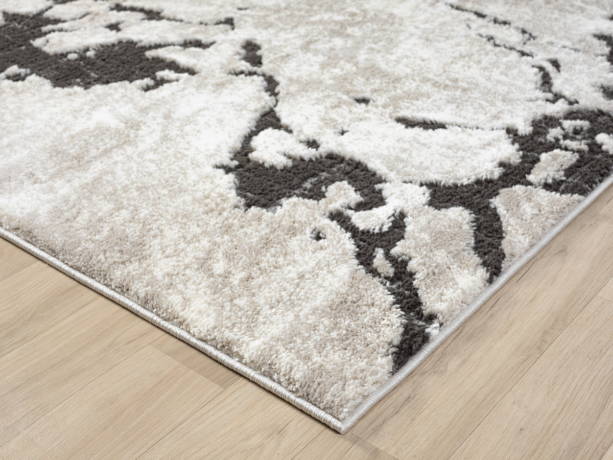 Mocha Eleanor Astro embossed abstract rug, corner fold detail