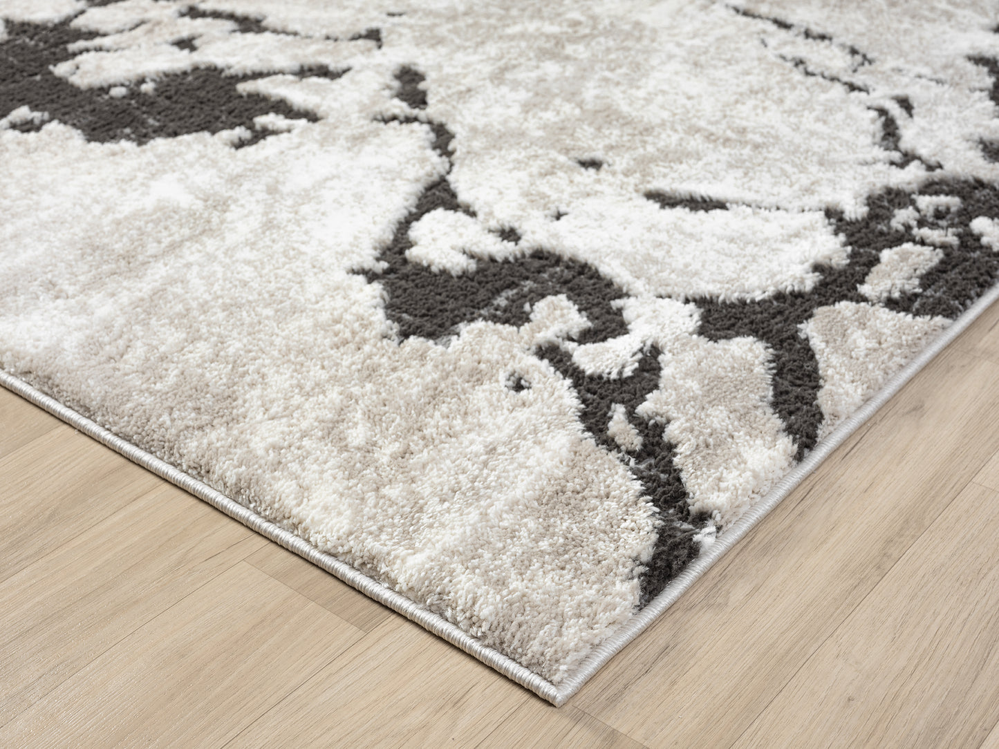 Mocha Eleanor Astro embossed abstract rug, corner fold detail