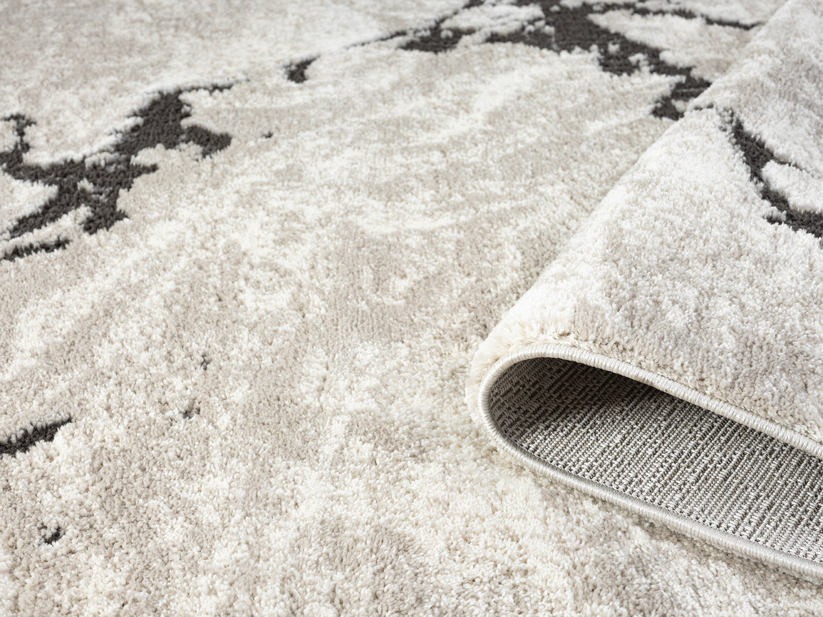 Mocha Eleanor Astro embossed abstract rug, rolled view