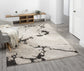 Mocha Eleanor Astro embossed abstract rug, in a room setting