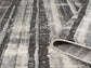 Grey Eleanor Linear embossed abstract rug, rolled view