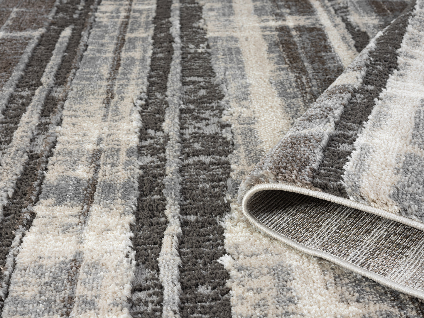 Grey Eleanor Linear embossed abstract rug, rolled view