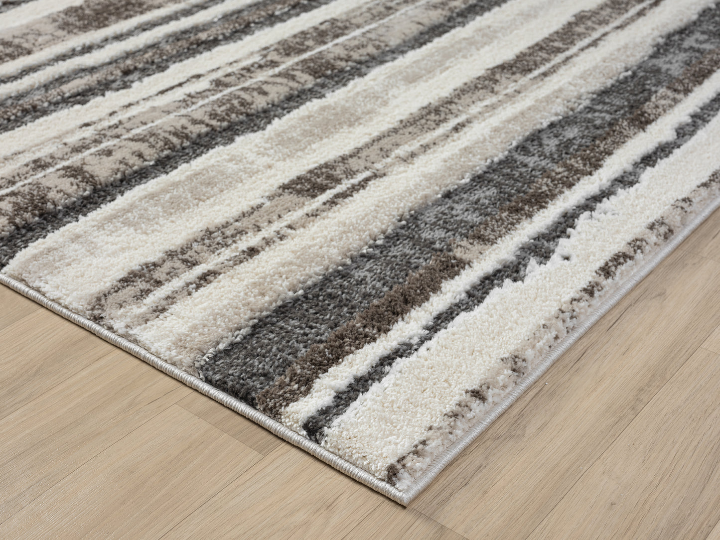 Mocha Eleanor Linear embossed abstract rug, corner fold detail
