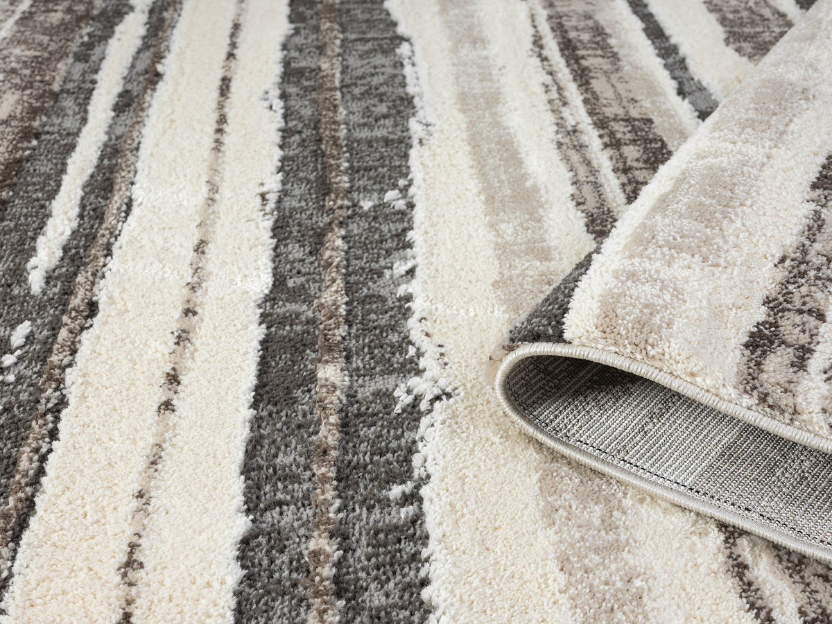Mocha Eleanor Linear embossed abstract rug, rolled view