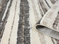 Mocha Eleanor Linear embossed abstract rug, rolled view
