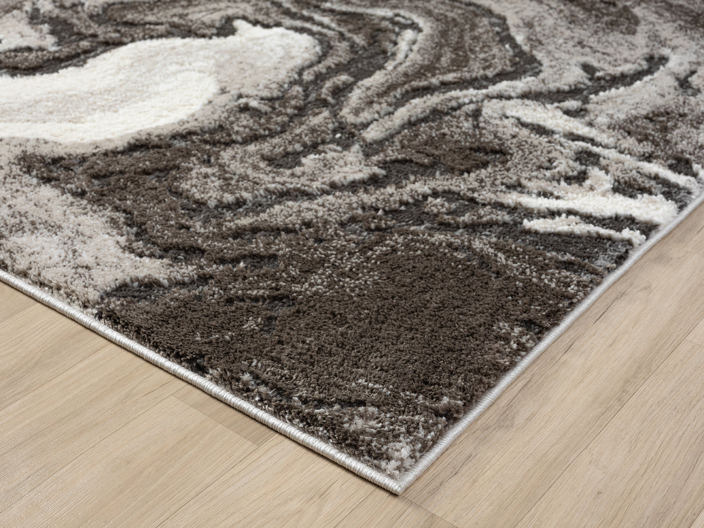 Mocha Eleanor Marble embossed abstract rug, corner fold detail