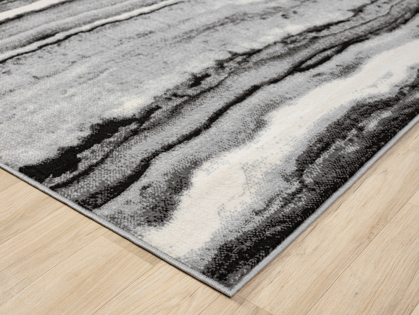 Grey Obsidian Coast monochrome rug, corner fold detail