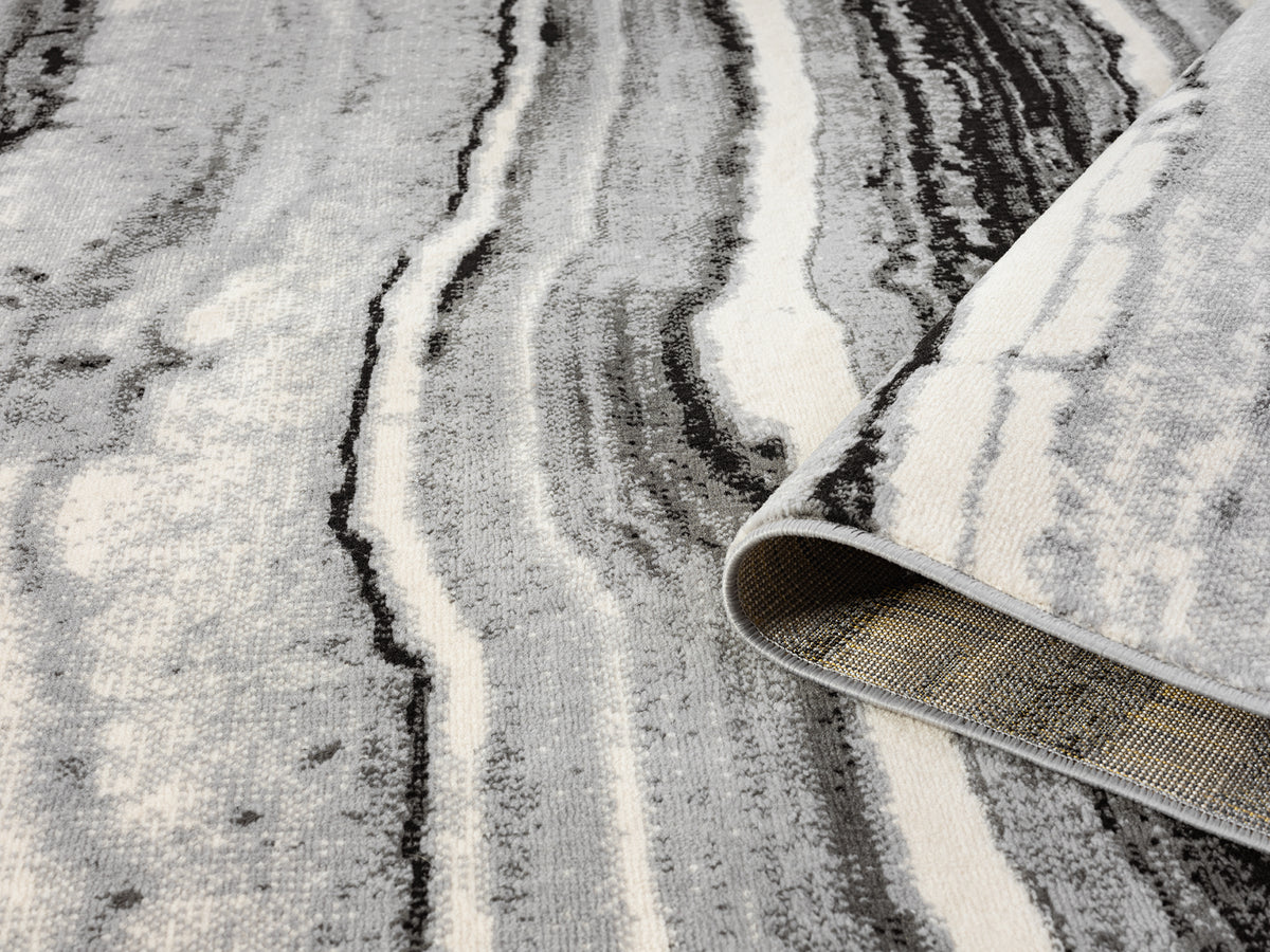 Grey Obsidian Coast monochrome rug, rolled view