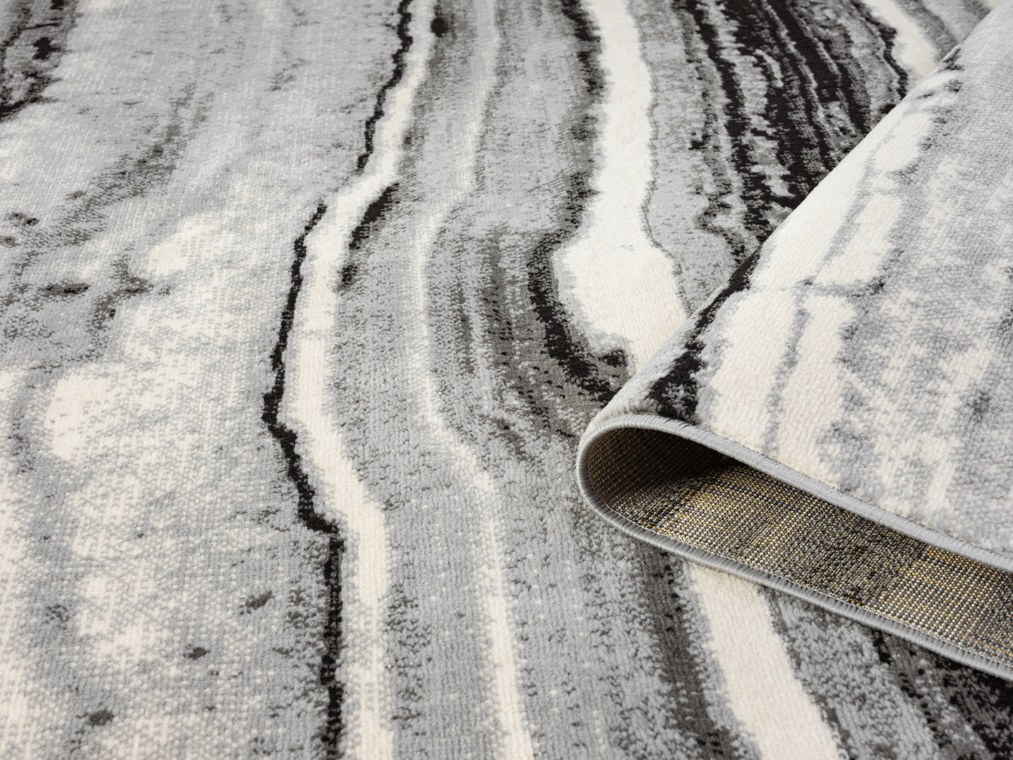 Grey Obsidian Coast monochrome rug, rolled view