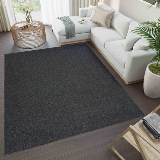 Dark Grey Simple easy care rug, in a room setting