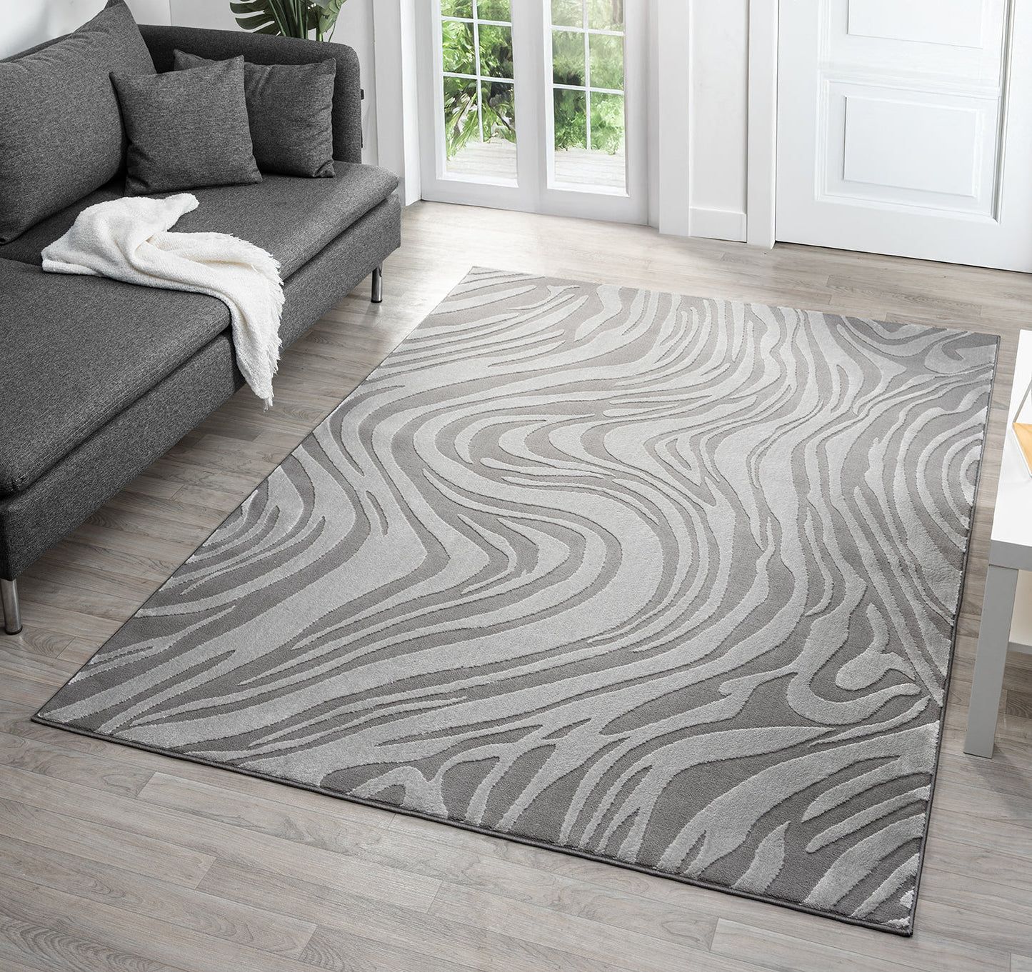 Anthracite Vellure Marble textured geometric rug, in a room setting